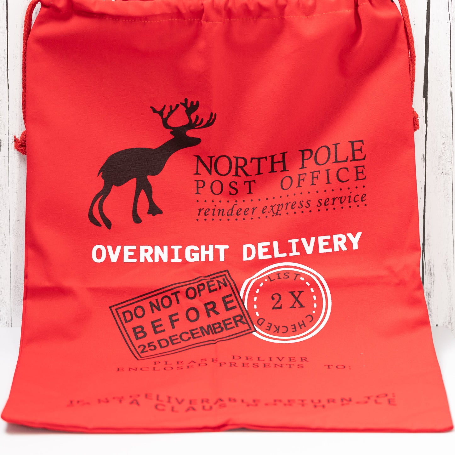 Christmas Gift Bags | Reusable Oversized Fabric with Drawstring Cord - North Pole Post Office Overnight Delivery Logo